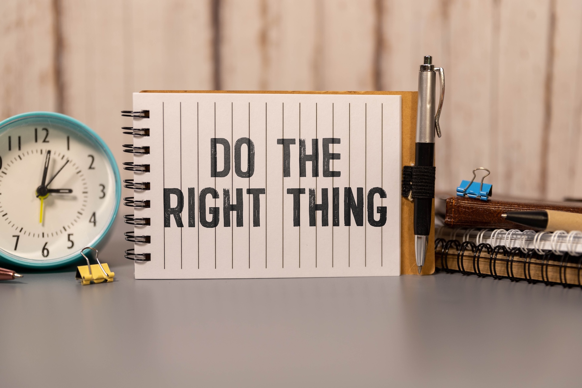 Do the right thing. text on torn paper on white backing.