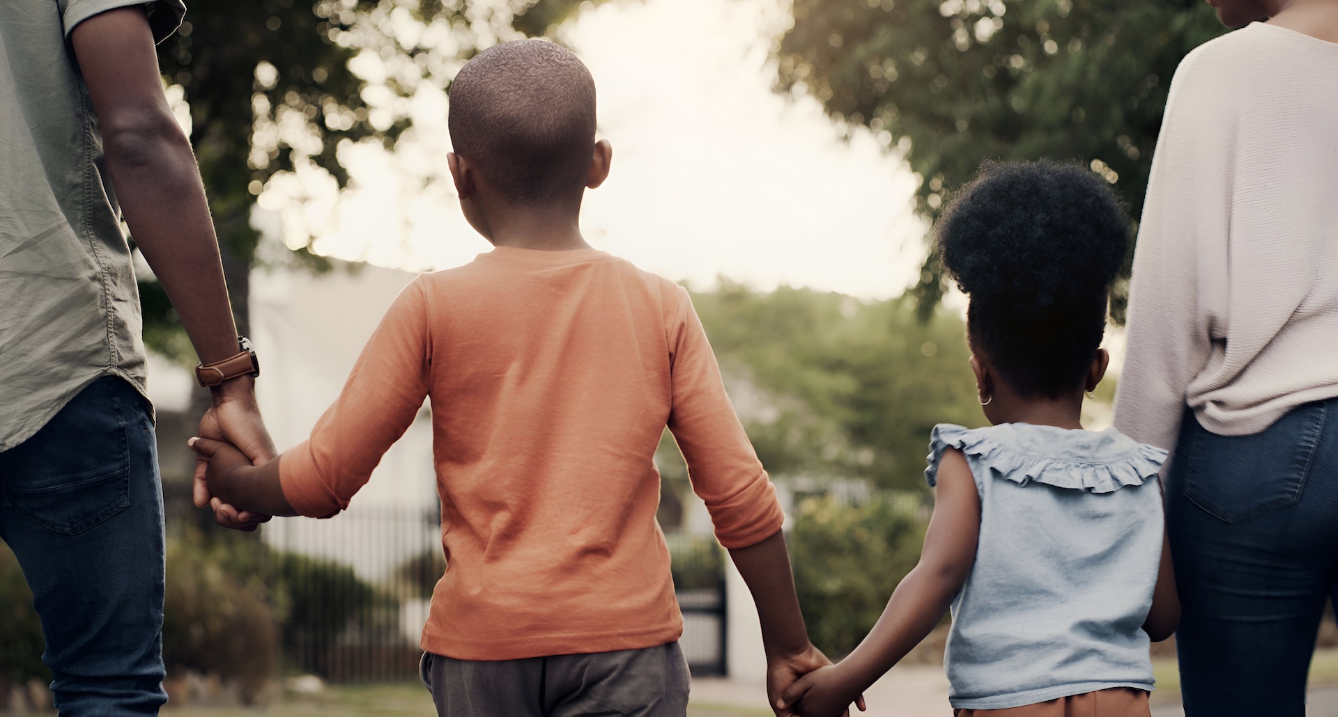 Back holding hands black family walking together road their neighborhood love